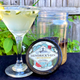 Hendrick's gin pickle cocktail in martini glass beside jar of pickles